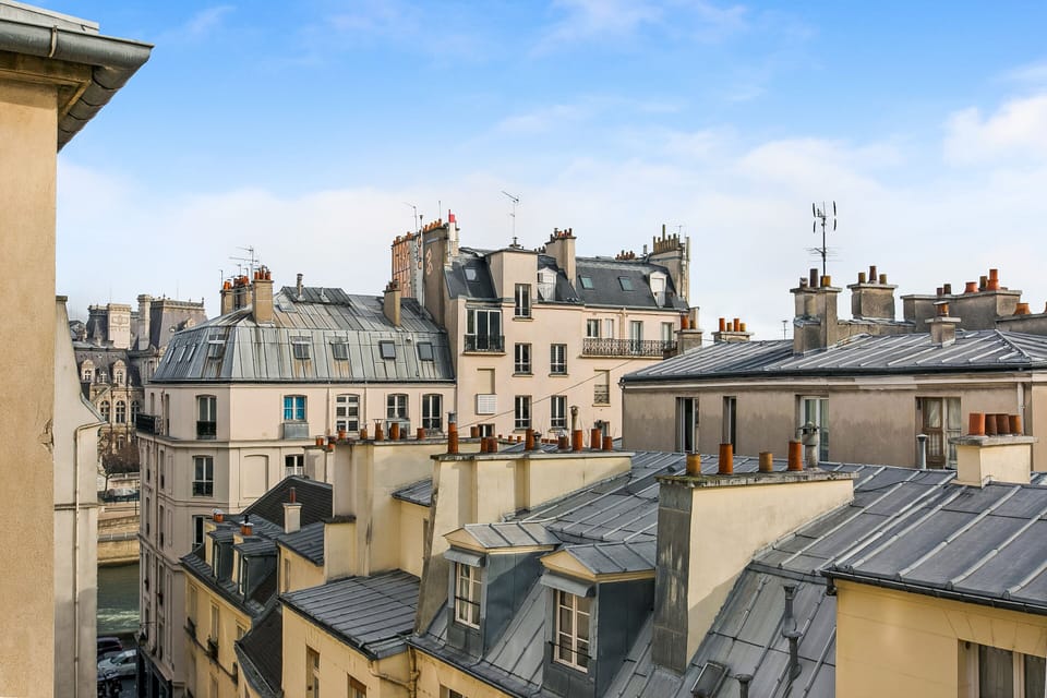 a "Like a Postcard View from the Living room with a side view on The Seine