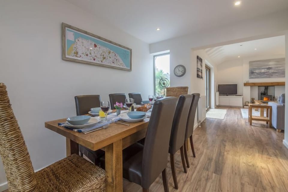 Ground floor: Dining area with large table and seating for eight