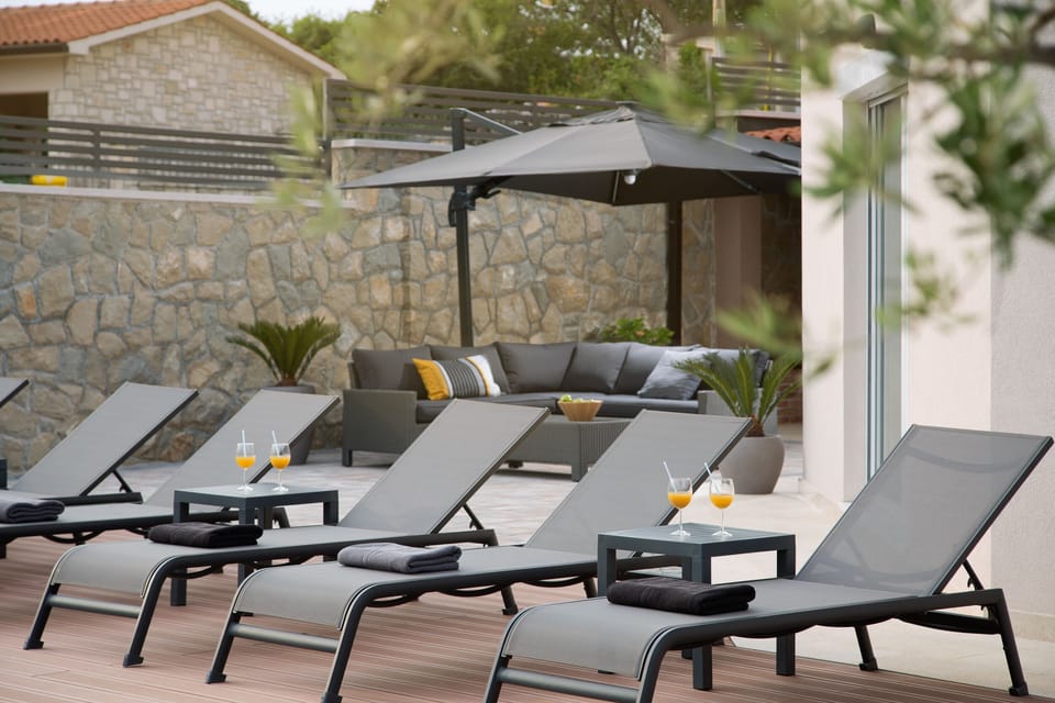 There are 8 comfortable sunbeds on the wooden deck around the pool