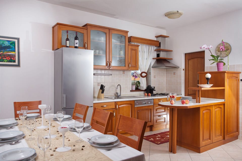 The living room and the well equipped kitchen