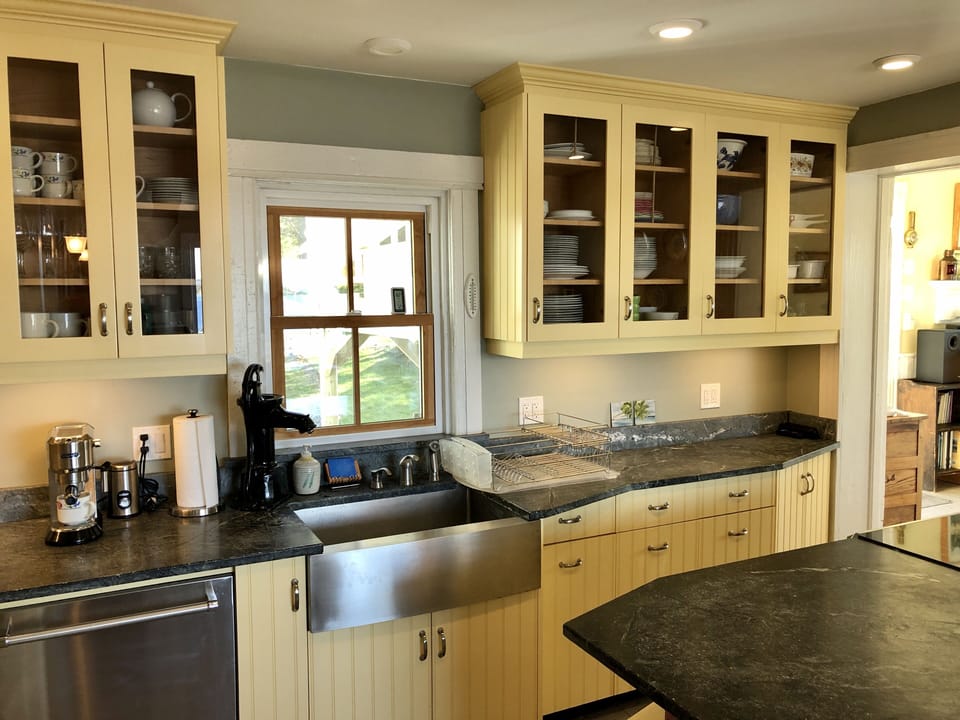 Handmade cabinets, Brazilian soapstone counters, dishwasher, farmhouse sink.