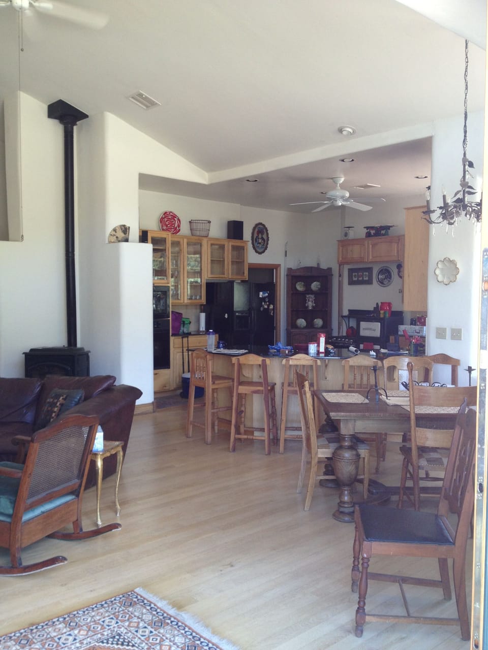 Open plan full kitchen with peninsula bar seating, great room pellet furnace