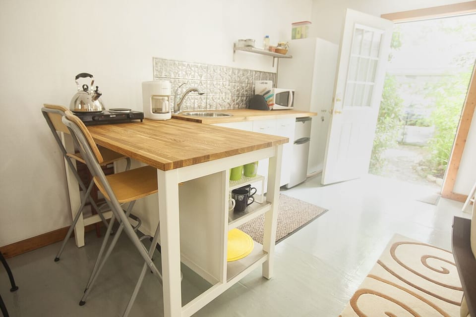 The kitchenette overlooks the garden through a french door.