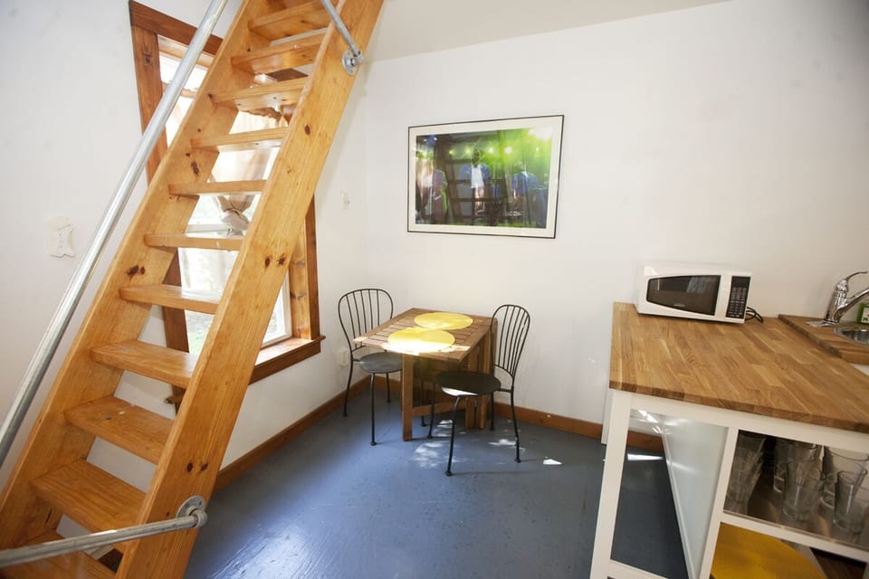 Cute little dining area under the stairs. Fabulous photos of Austin music.