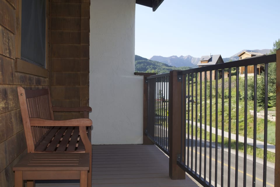 Balcony with bench and table.