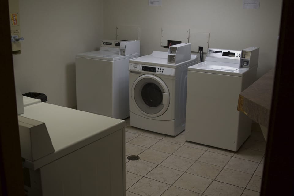 Coin laundry located in basement.