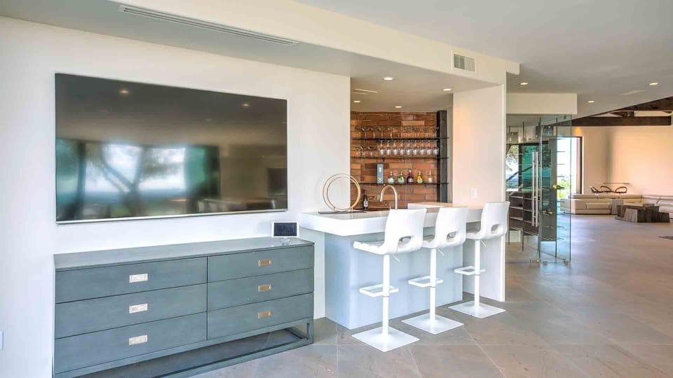 Second living room w/ bar & bar seating, TV & seating off the kitchen