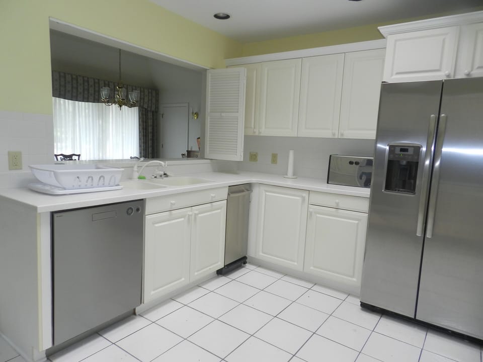 looking into the dining room. Showing dishwasher and trash compactor.