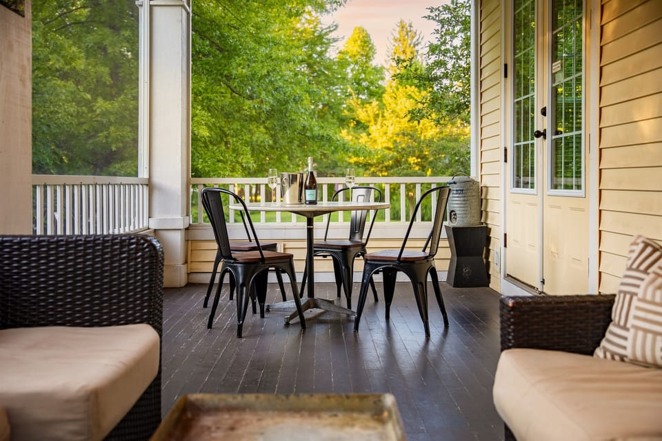 Screened in porch with lounge area, and dining area