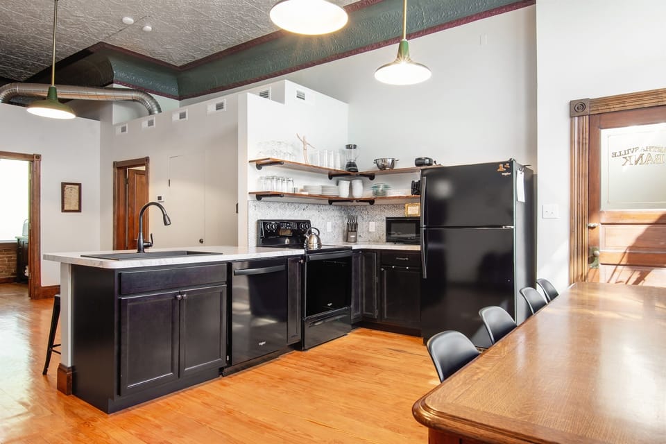 Main level kitchen with large kitchen table at the Bank Haus.