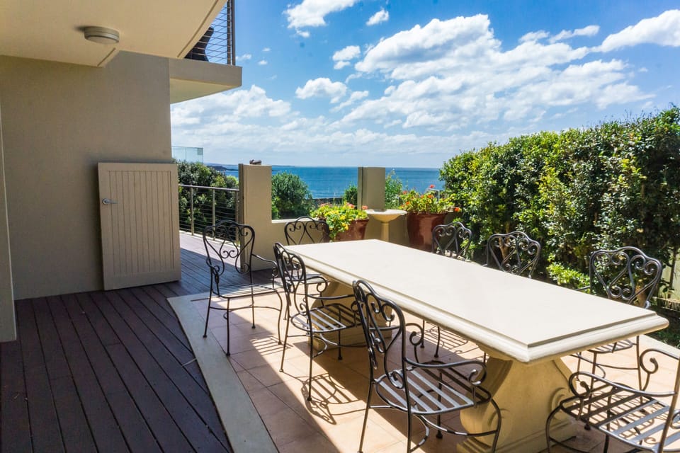 Sunny, private courtyard and lawn (behind) with access to the cliff-top walk.