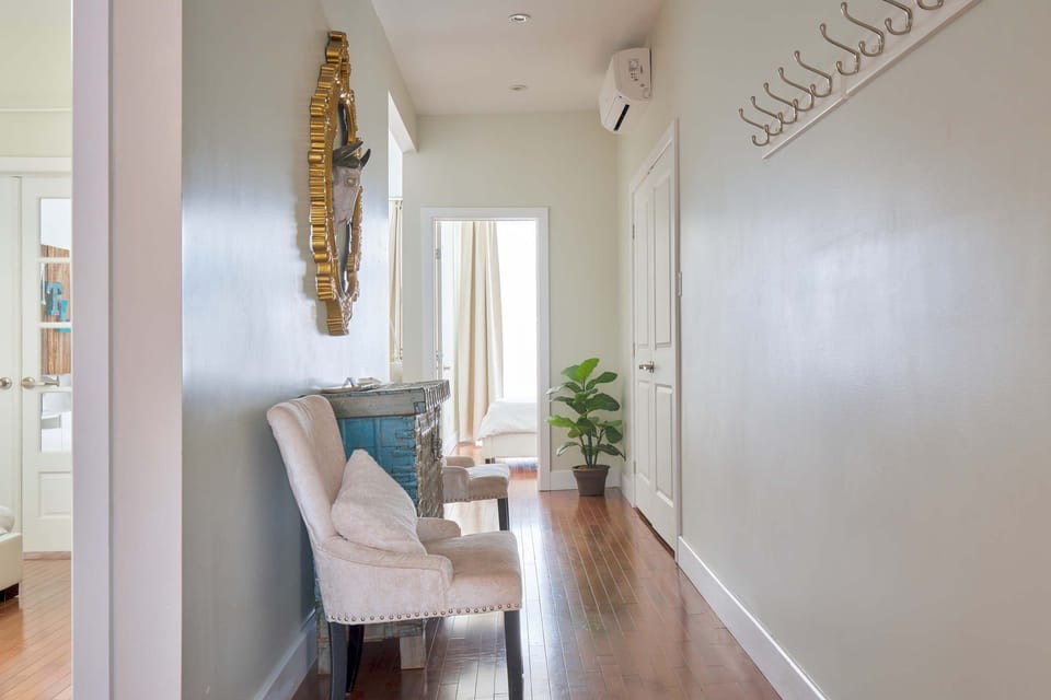 Entrance, A/C unit, laundry space behind the doors