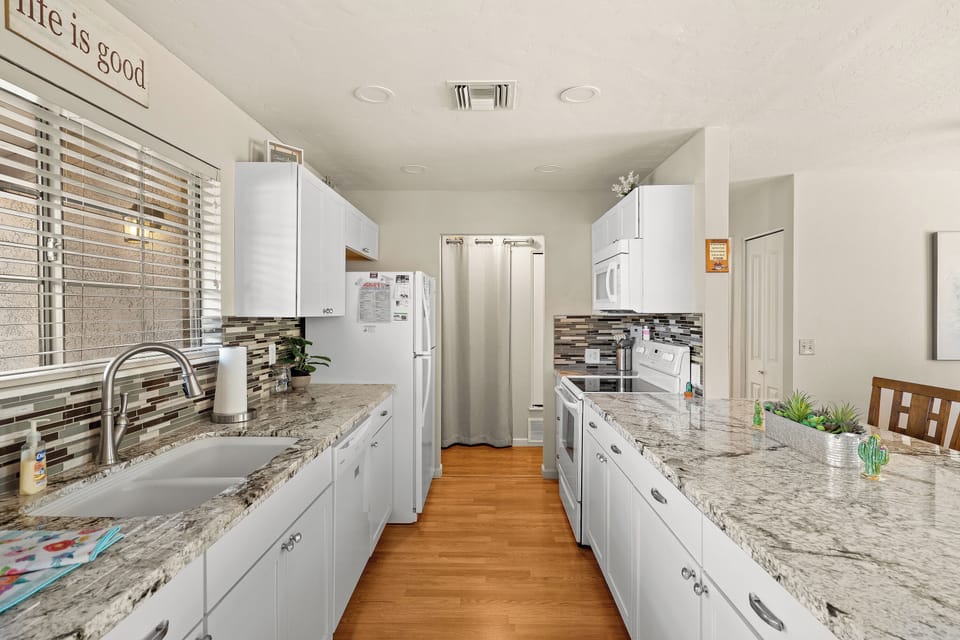 Galley kitchen with large island and seating for up to 4 at the counter