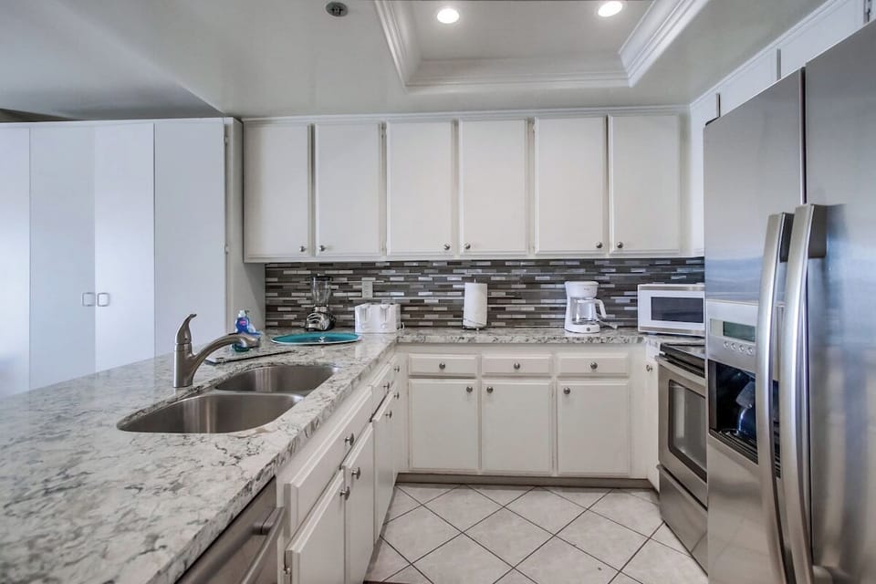 Kitchen is fully equipped for meals at home. Complete with stainless steel appliances including a dishwasher