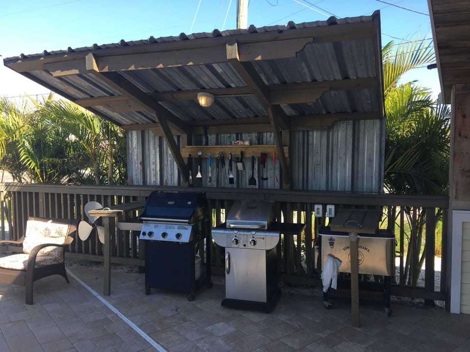 fully equipped outdoor grilling area shared between three houses on the property