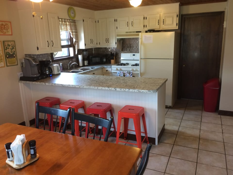 kitchen and dining, breakfast bar and stools; door to laundry