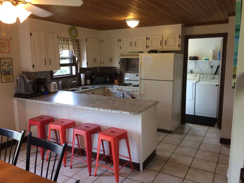 kitchen and dining, breakfast bar and stools; door to laundry