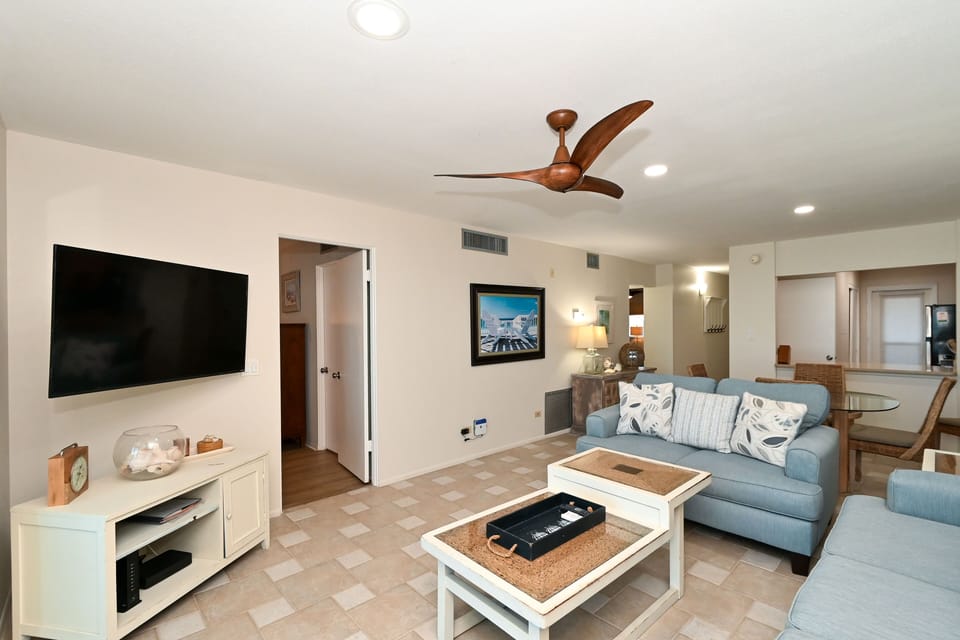 Spacious living room with HDTV, view to Lanai, beach and Gulf of Mexico