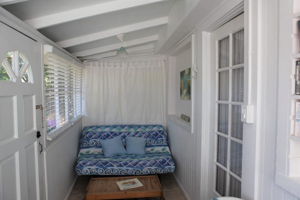 Porch room with sofa bed. Right door into living area.  Left to outside front 