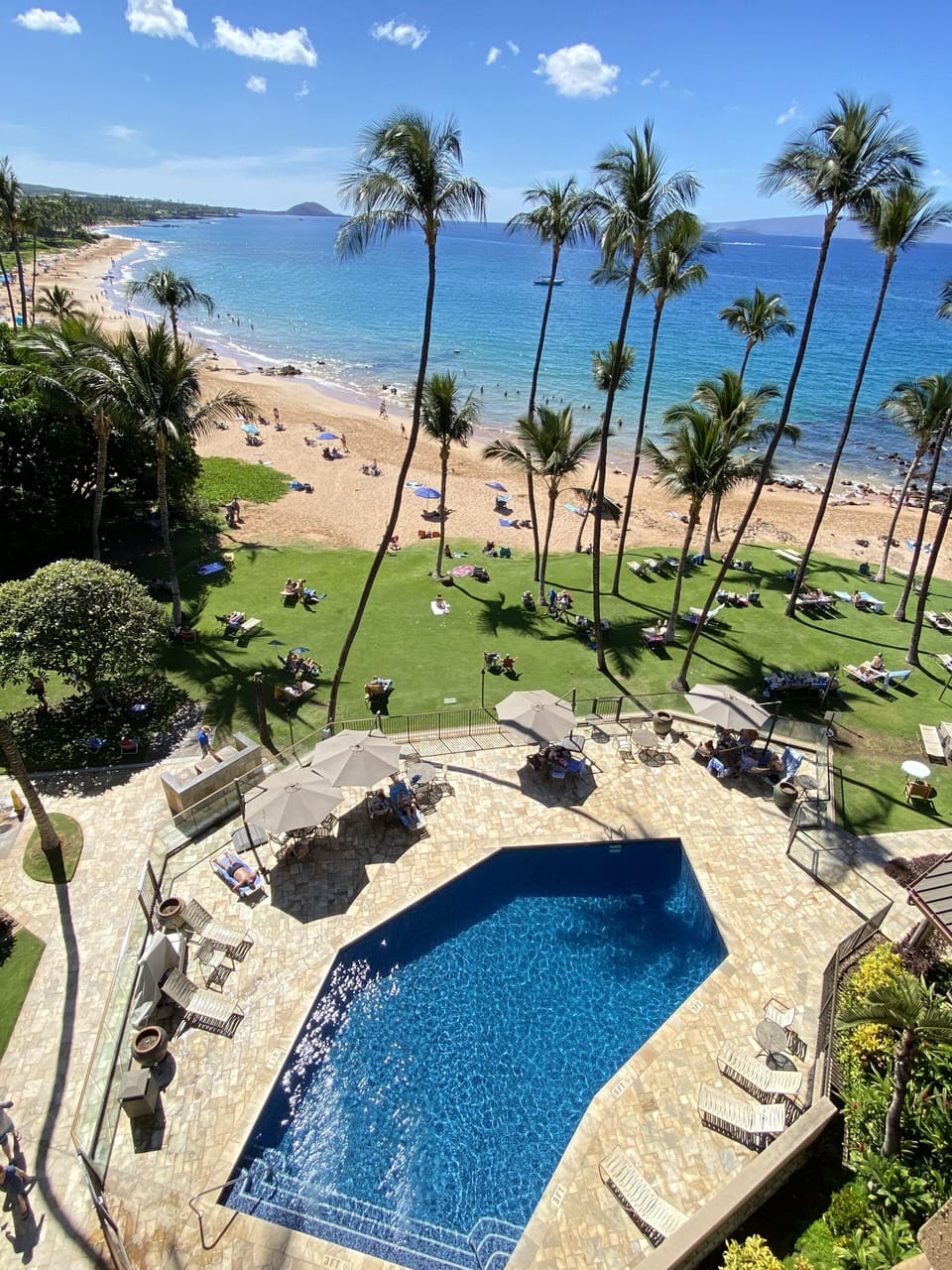 Looking from lanai, the heated warm saltwater pool sits right next to the beach!