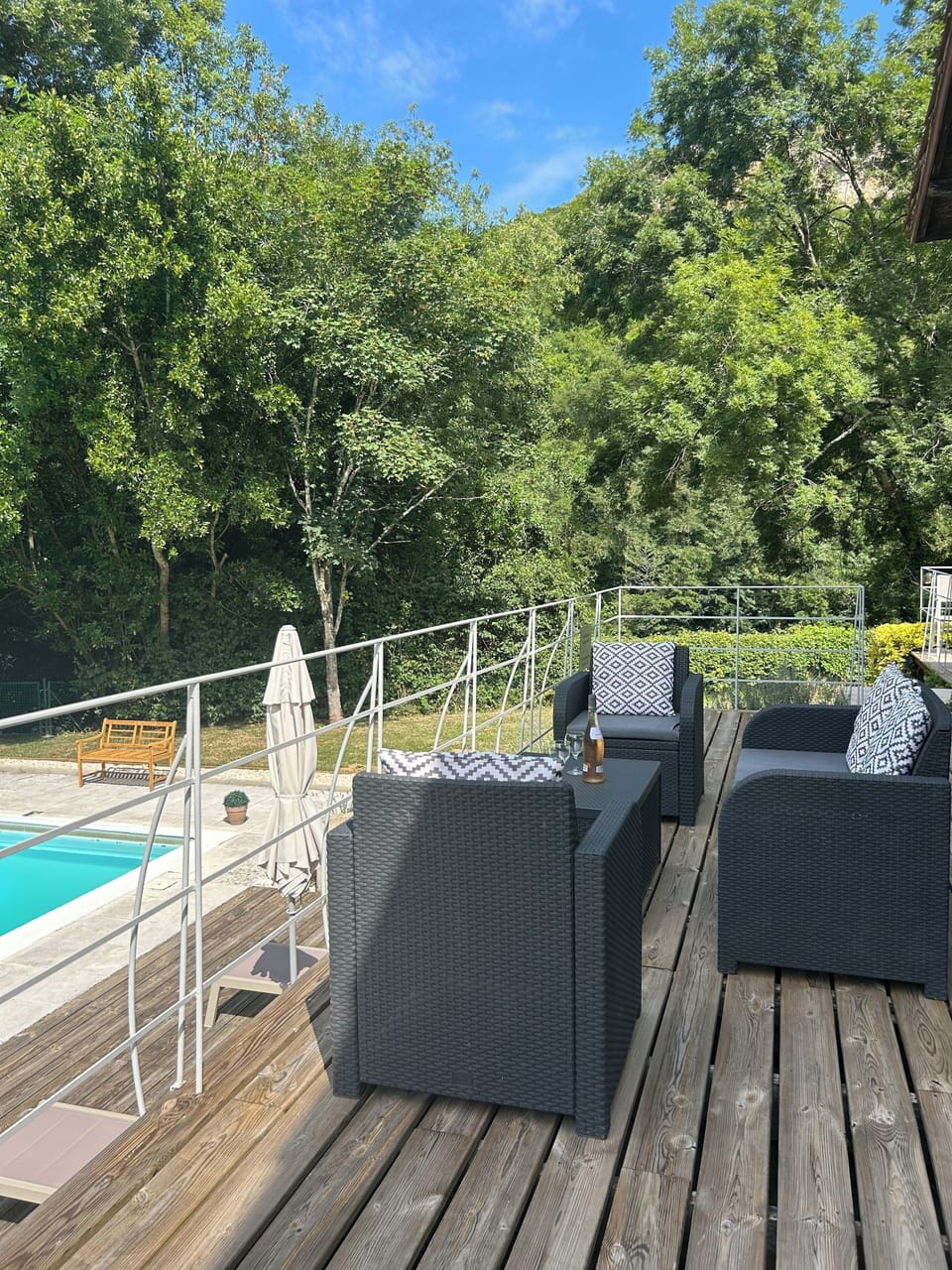Enjoying a glass of champagne on the terrace overlooking the pool and river