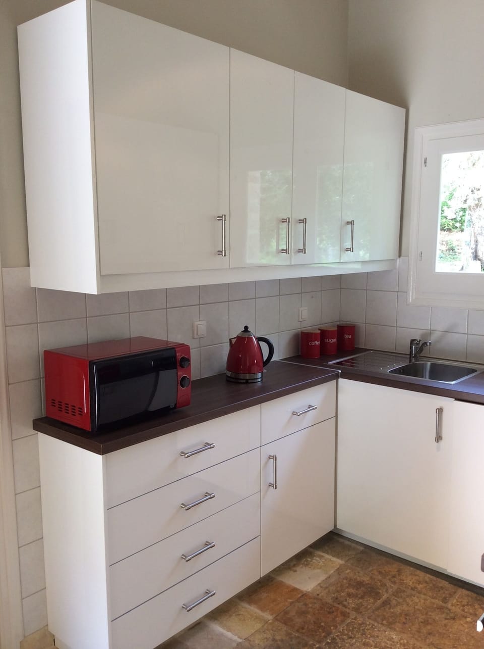 Fully fitted kitchen with microwave.