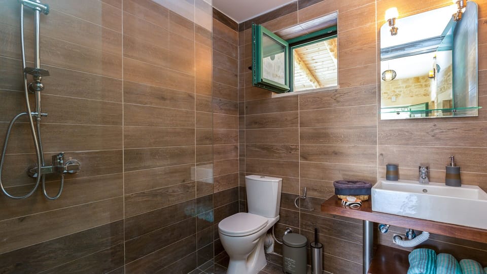 Bathroom with shower next to the single beds bedrooms