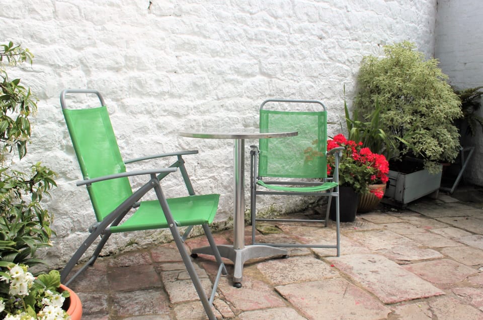 Patio. There are four garden chairs available and one small bistro table.