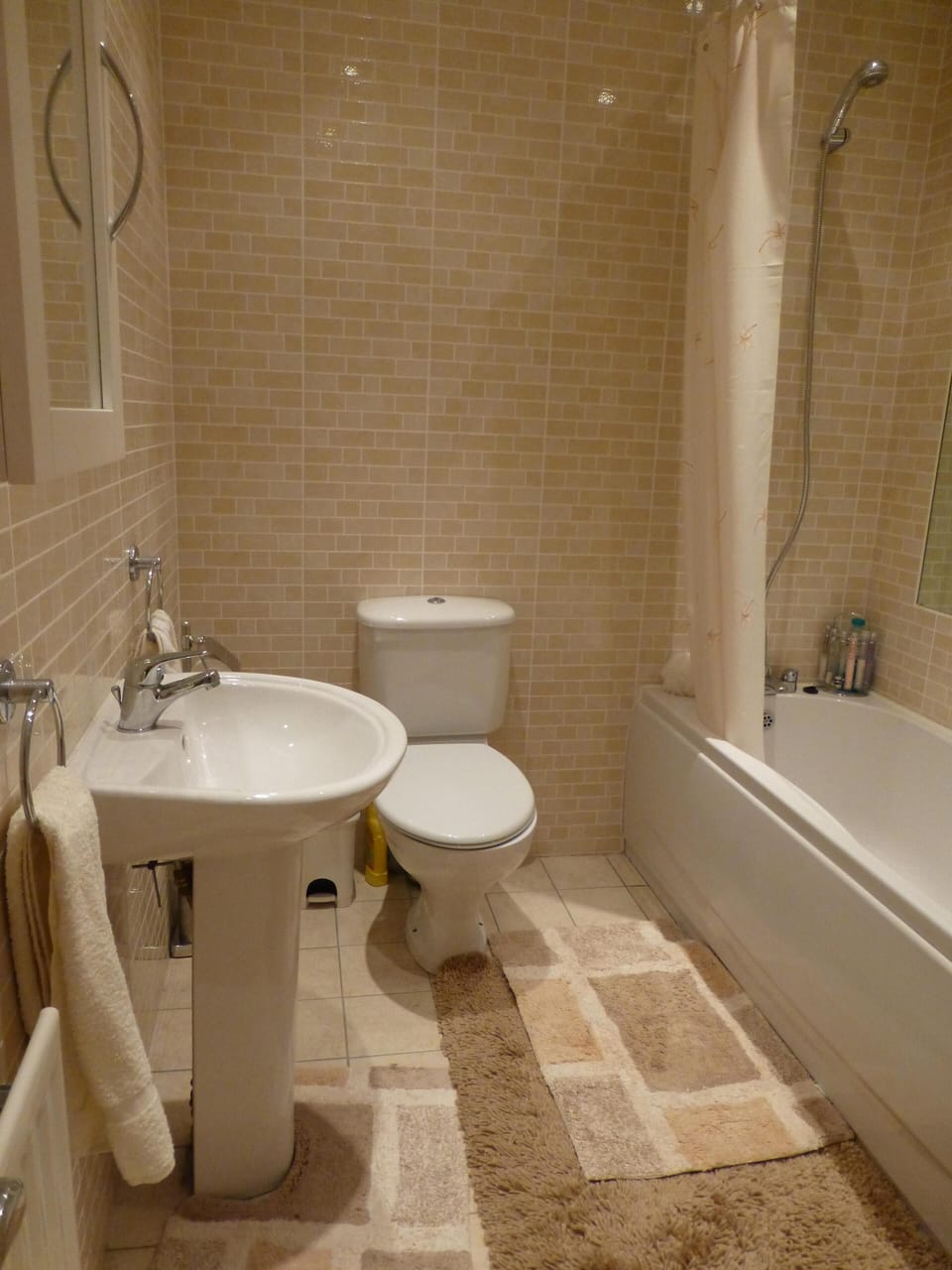 Spacious, fully tiled, guest bathroom with both shower and bath