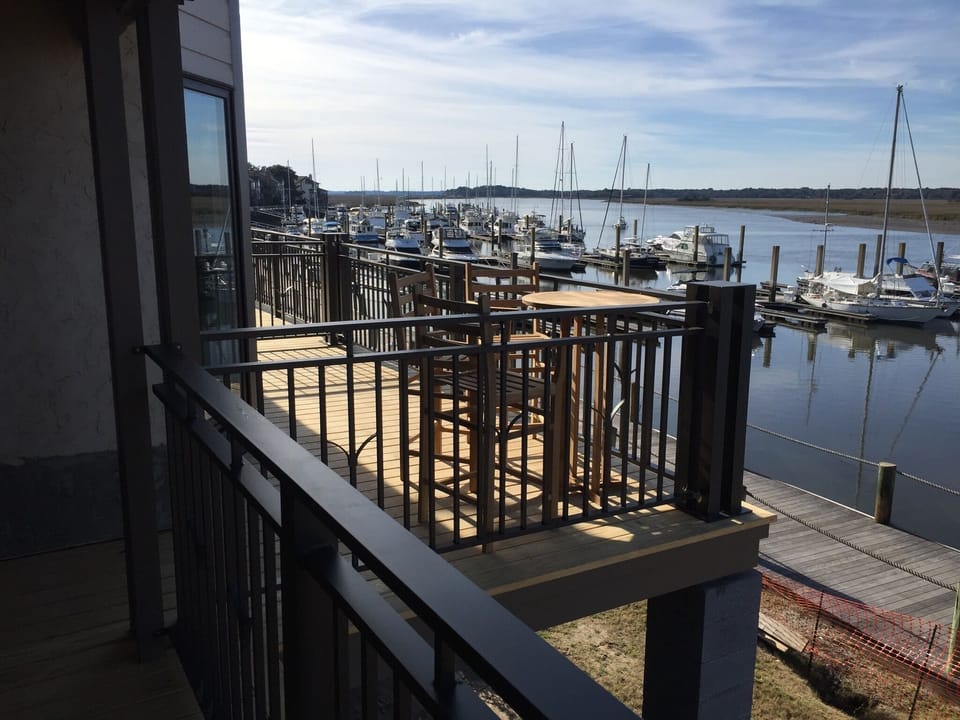 From the kitchen or the living room, step out on the large deck to enjoy the sun
