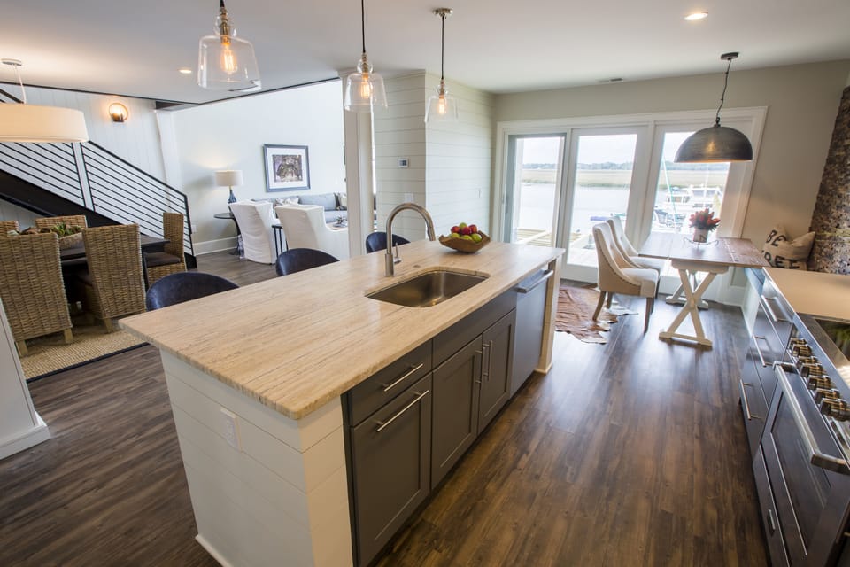 From the kitchen, look to the breakfast area and beyond to the deck and river.