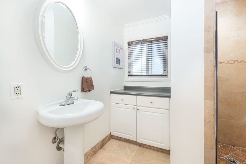 The first guest bedroom's en-suite bathroom with step-in shower.
                