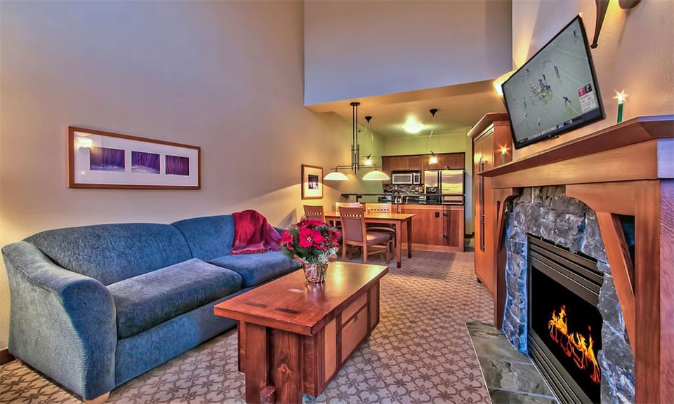 Living room with gas fireplace, sofabed and LED HDTV.