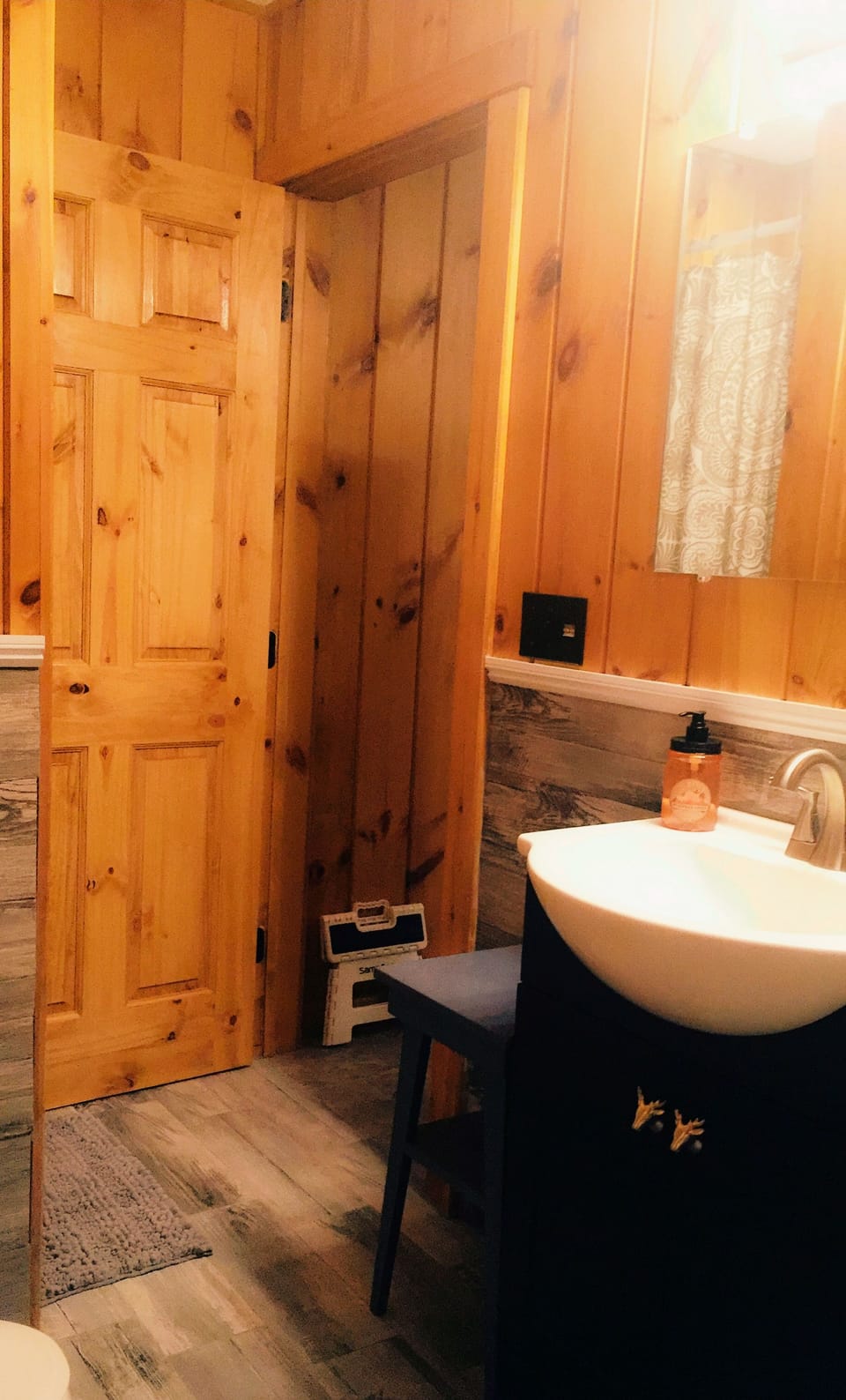 First floor bathroom with a stand up shower and modern wood like tiles 
