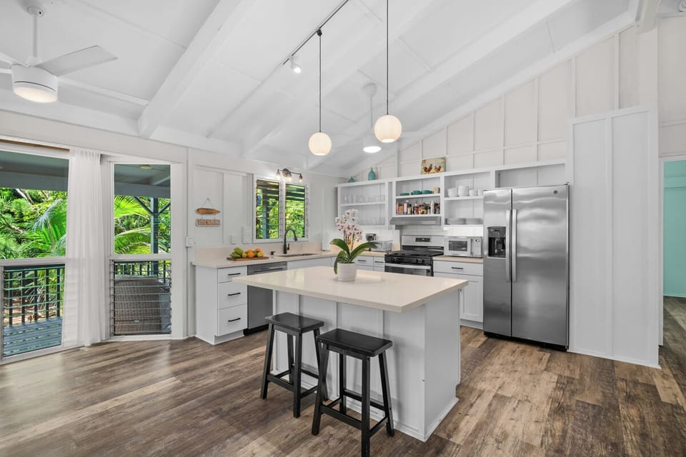 Pull up a stool at the white island while dinner comes together under the pendants.