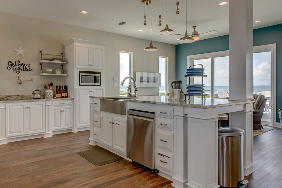 Your fully equipped kitchen welcomes you with ocean views, granite countertops, and modern appliances perfect for creating memorable meals together.