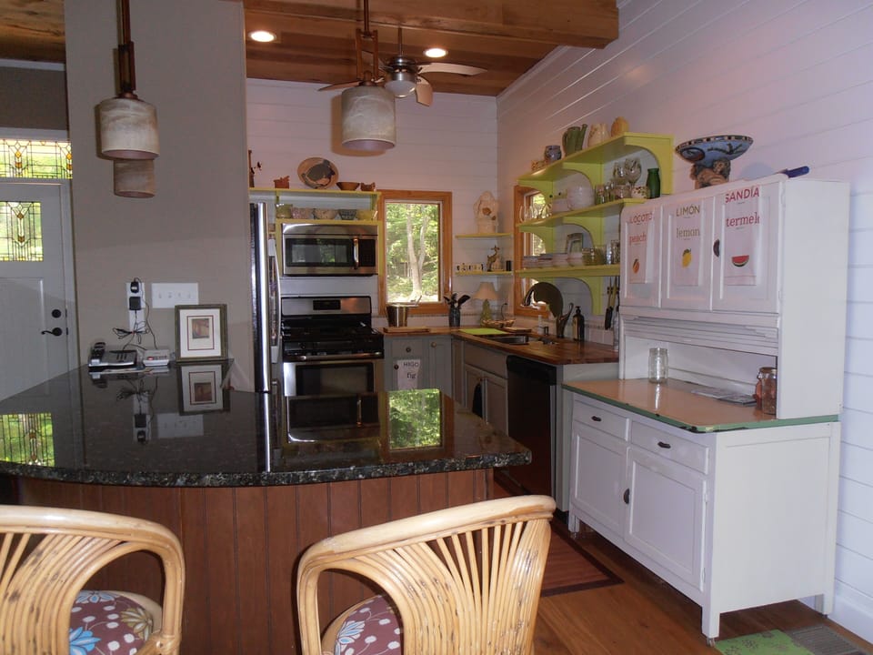 Kitchen - Granite and wood countertops, 'touch' faucet, antique hutch