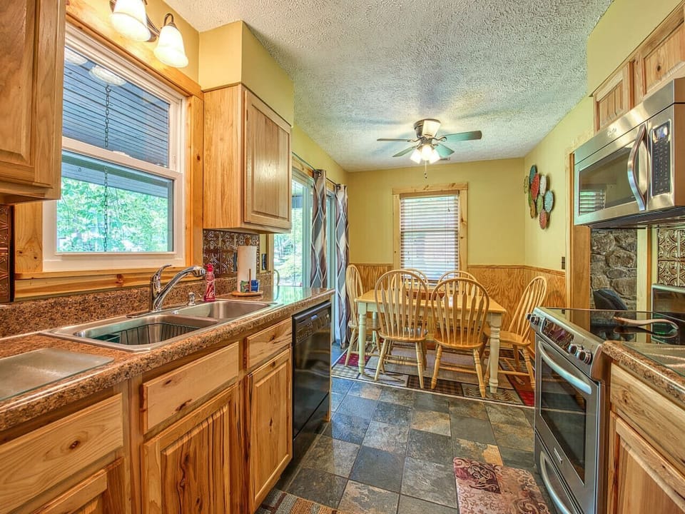 Wonderfully equipped kitchen with access to back covered porch, creek and patio.