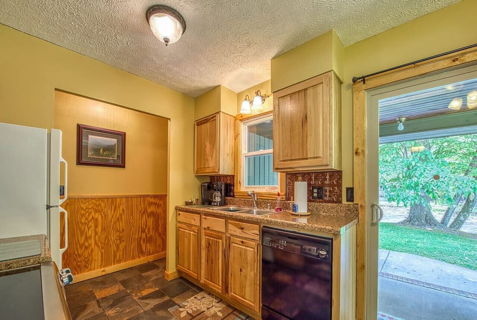 Laundry room off kitchen includes W/D, vacuum cleaners & cleaning supplies.