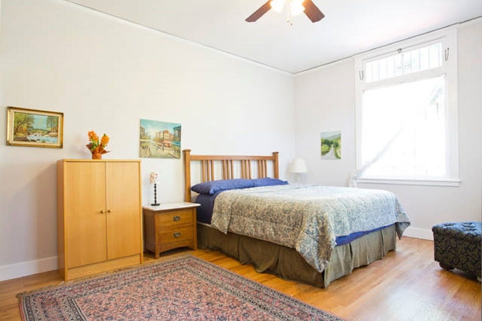 NE bedroom. Tons of light. Looks onto beautiful palm tree. Bathroom in room.