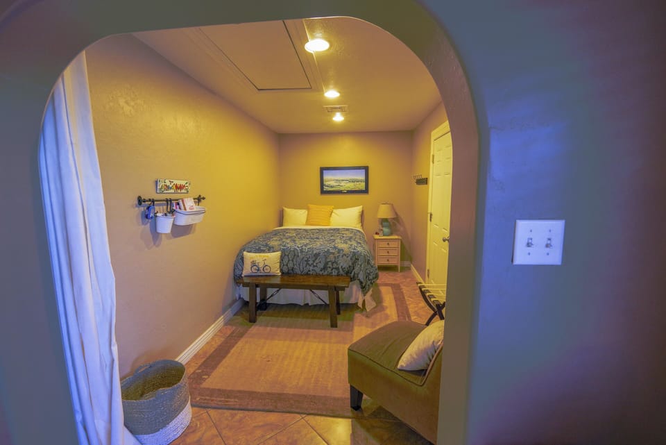 Queen bedroom next to the dining room with curtains for privacy.