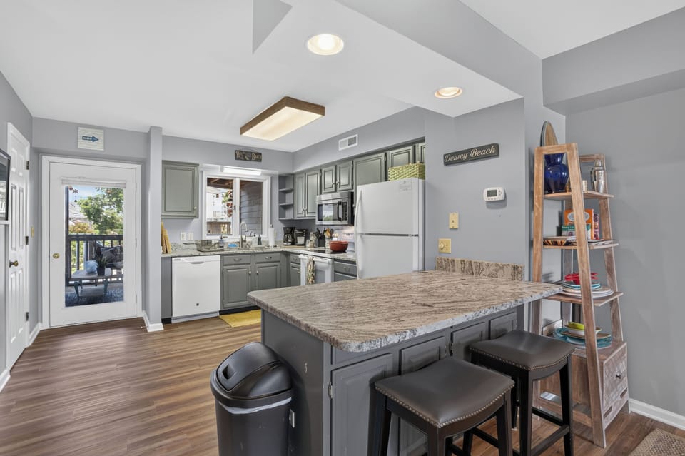Well-stocked kitchen with appliances, premium cookware, and all the essential gadgets needed for gourmet meal preparation, including a coffee maker, blender, and toaster.
