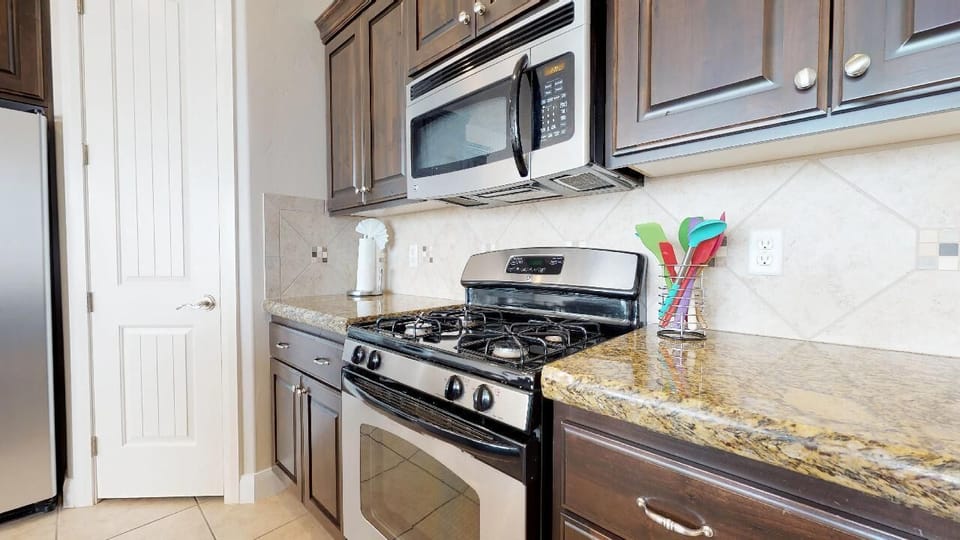 Fully stocked gourmet kitchen  featuring stainless steel appliances