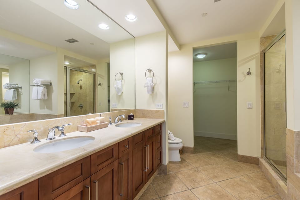 Dual vanities, soaking tub, and walk-in shower in the private ensuite bath.