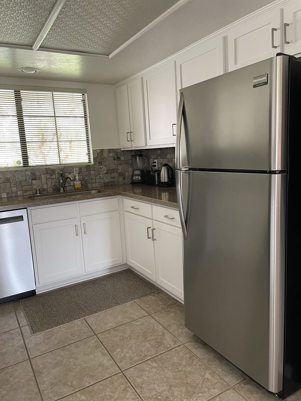 Updated kitchen with stainless steel appliances and quartz countertops.