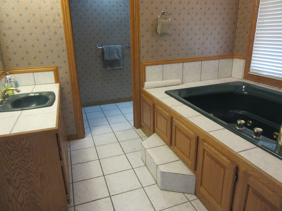 Bathroom downstairs. Through the door is a stool and shower.