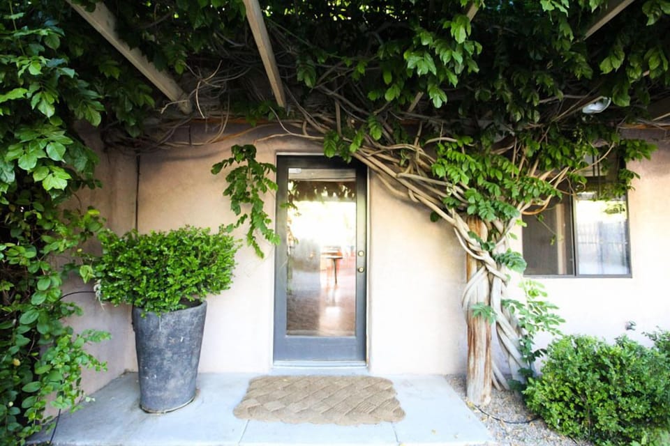 grand entrance flanked by lush greenery