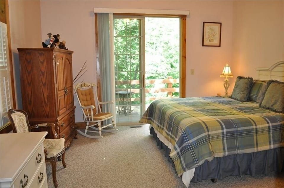 Master bedroom with private balcony overlooking pond and backyard.