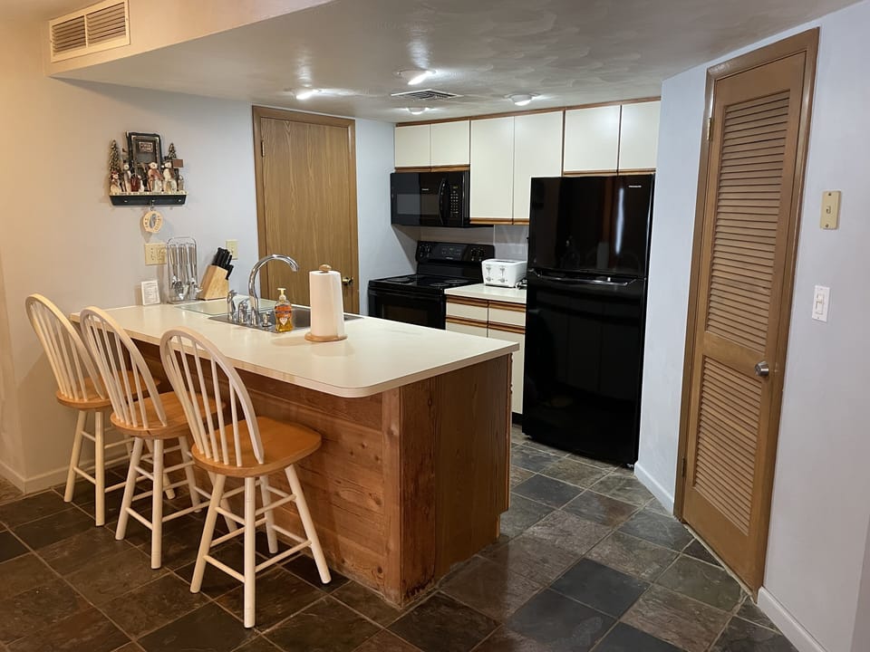 Newer Frigidaire appliances in the kitchen with real slate floors.