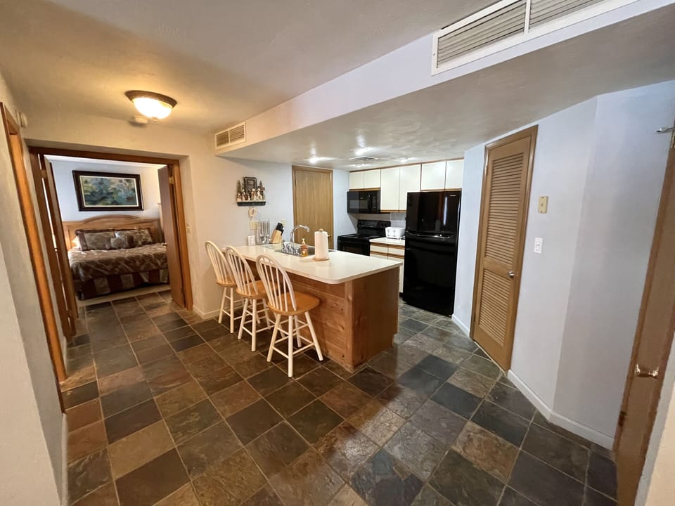 First primary bedroom with en-suite bath and double doors adjoins the kitchen.